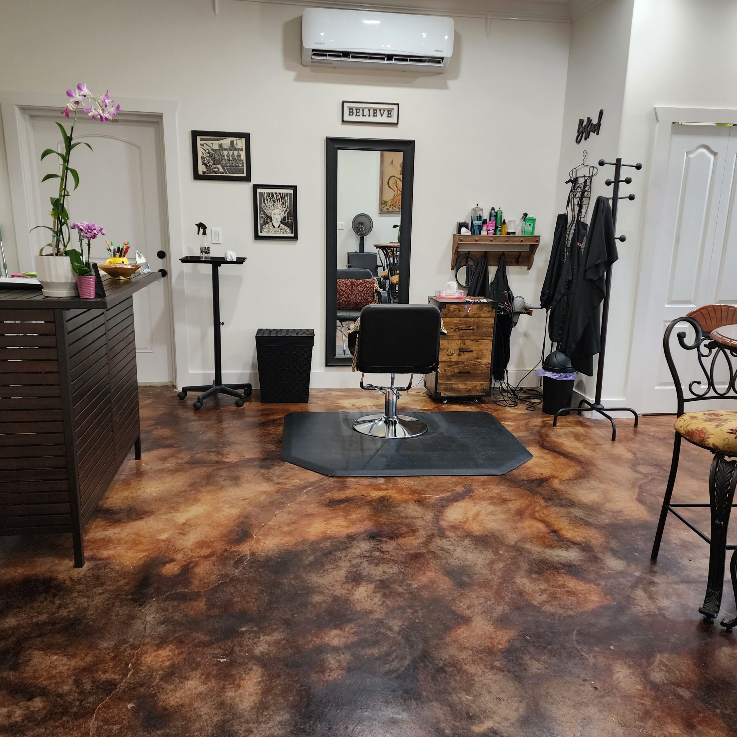 A cozy hair studio featuring a Coffee Brown and Malayan Buff acid-stained concrete floor, with swirling patterns that give the appearance of a well-worn leather
