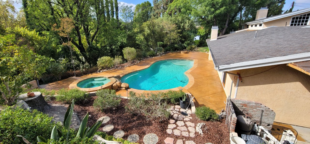 The same concrete space transformed into a vibrant backyard haven after staining with Yukon Gold Antiquing Stain and sealing with Solvent Based Acrylic Satin Concrete Sealer