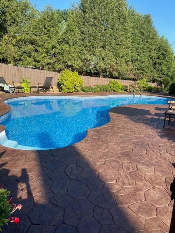 Post-stain photo of the stamped concrete pool deck, now rejuvenated with Aztec Brown Antiquing Stain and EasySeal Satin Sealer
