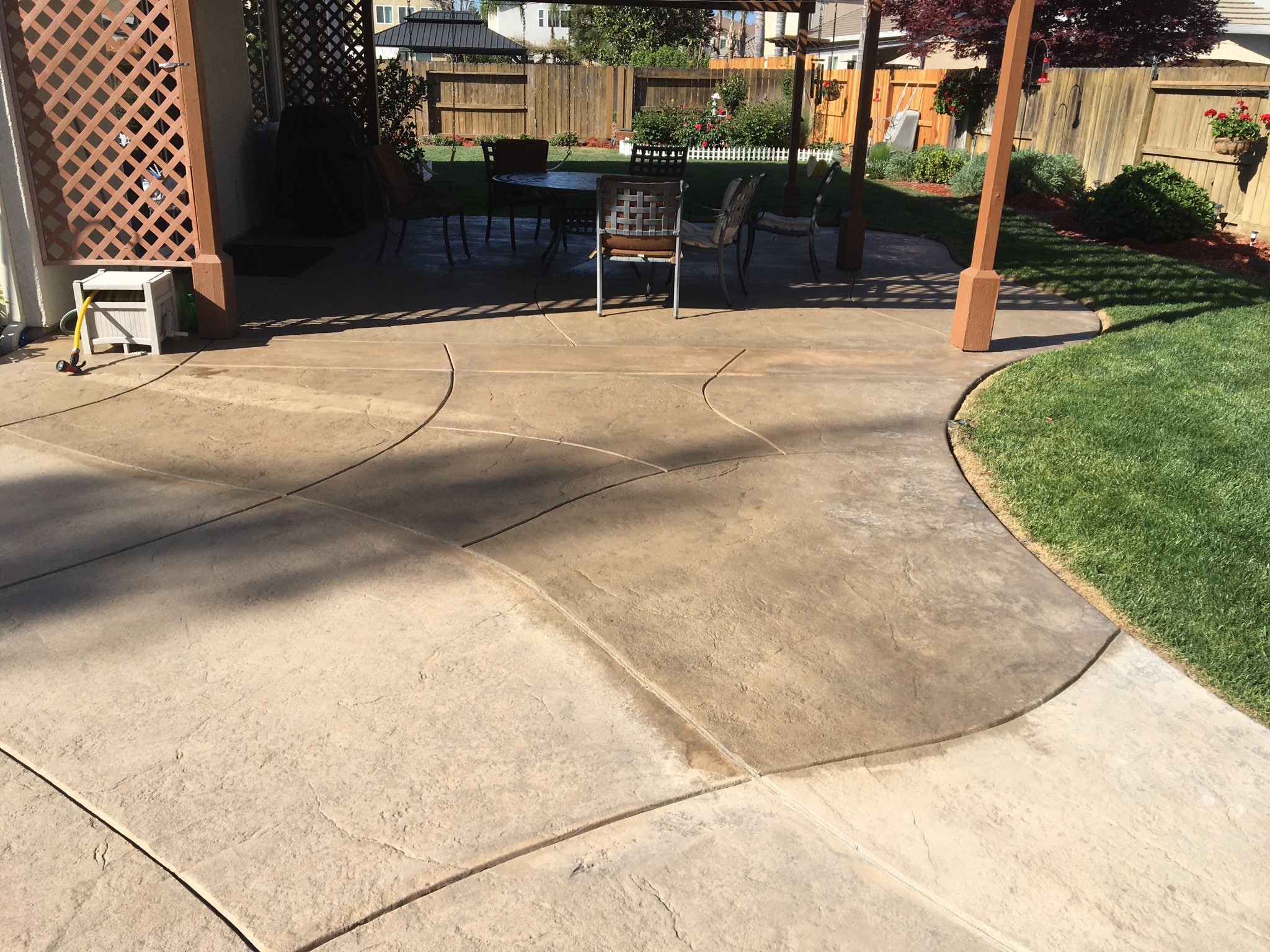 sealing process on the newly stained stamped concrete spa area