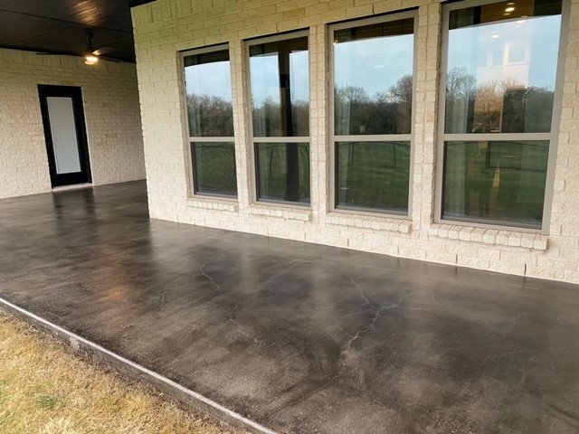 Black Antiquing stained broomed concrete covered patio surface