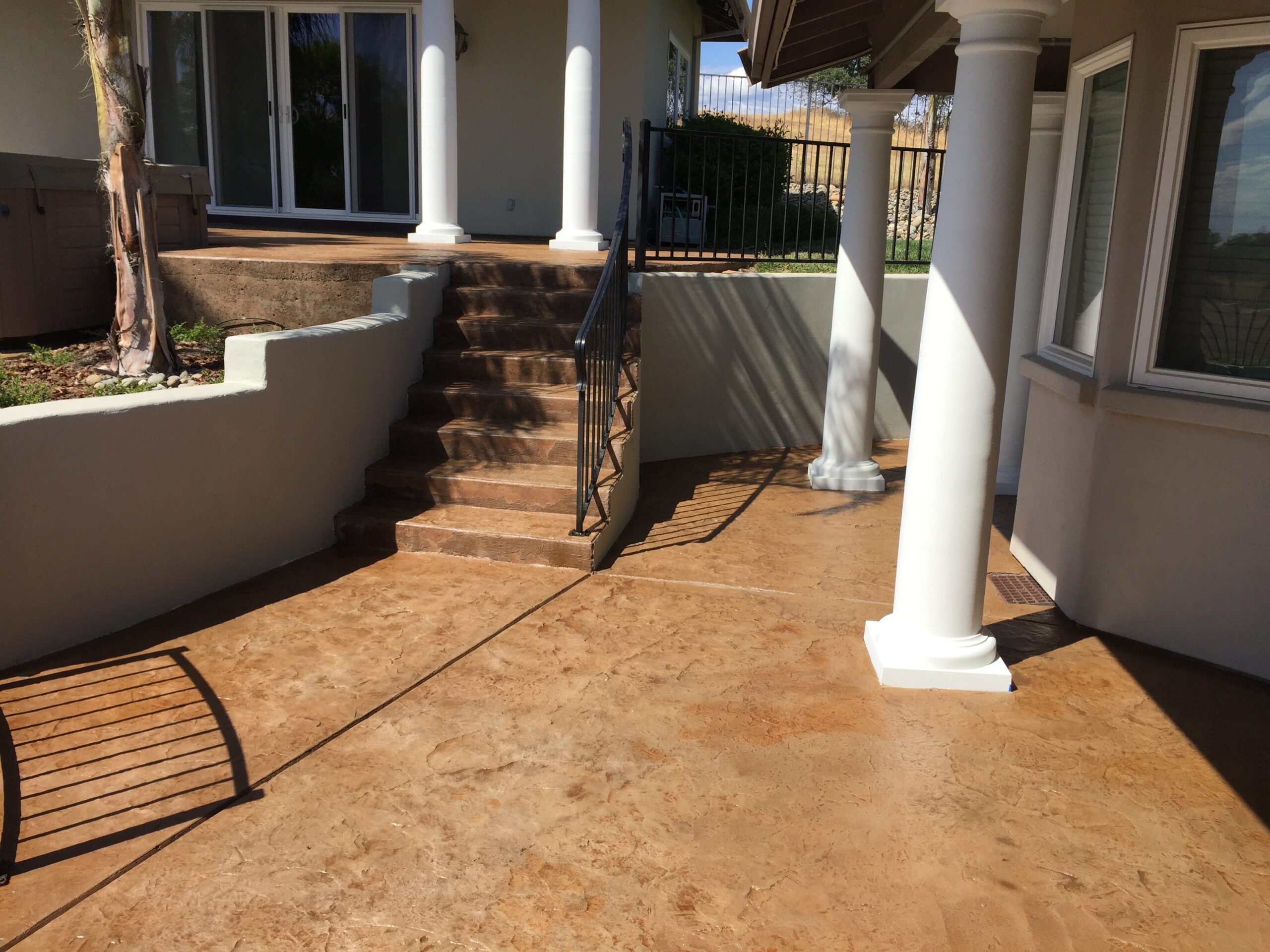 Stamped concrete patio stained with cumin Antiquing stain