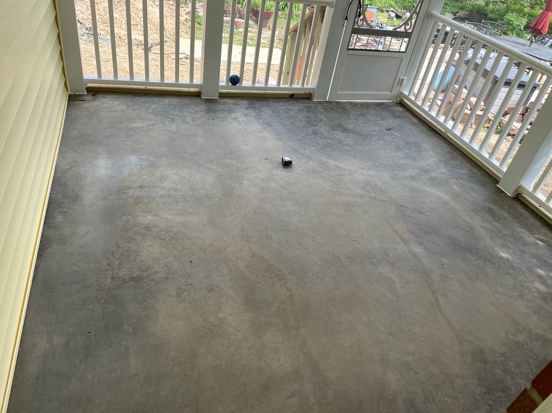 Before transformation: A plain, clean concrete floor of a porch