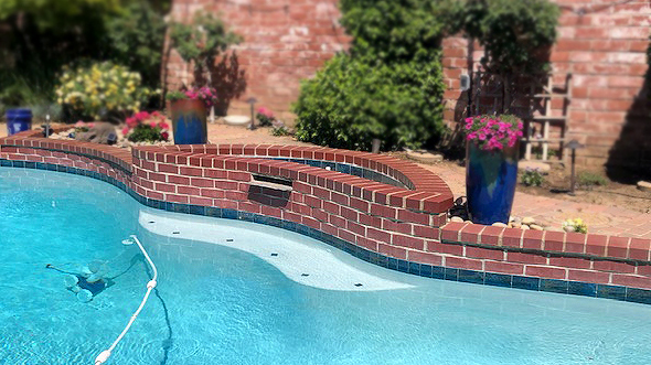 Restored faded concrete pool brick pavers