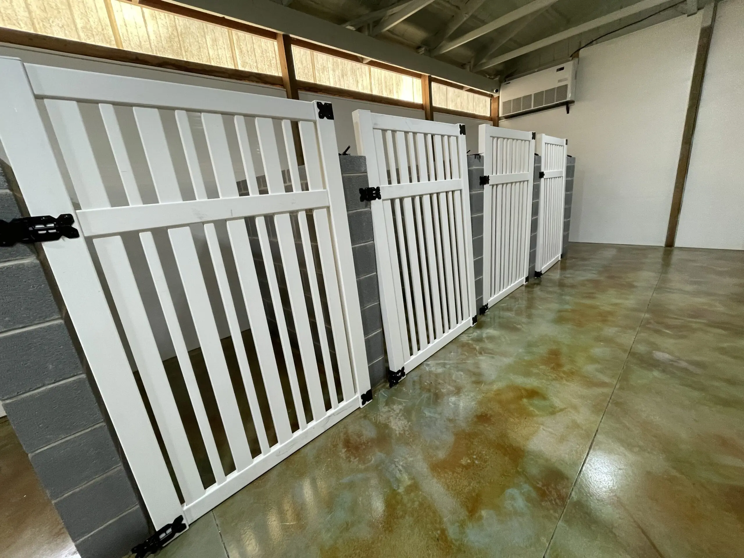 stained floor showcasing its green marbleized finish around the designated dog stall areas