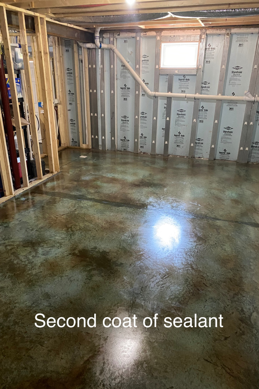 A photo of a concrete floor with the second coat of sealer applied, showing a glossy and protected surface