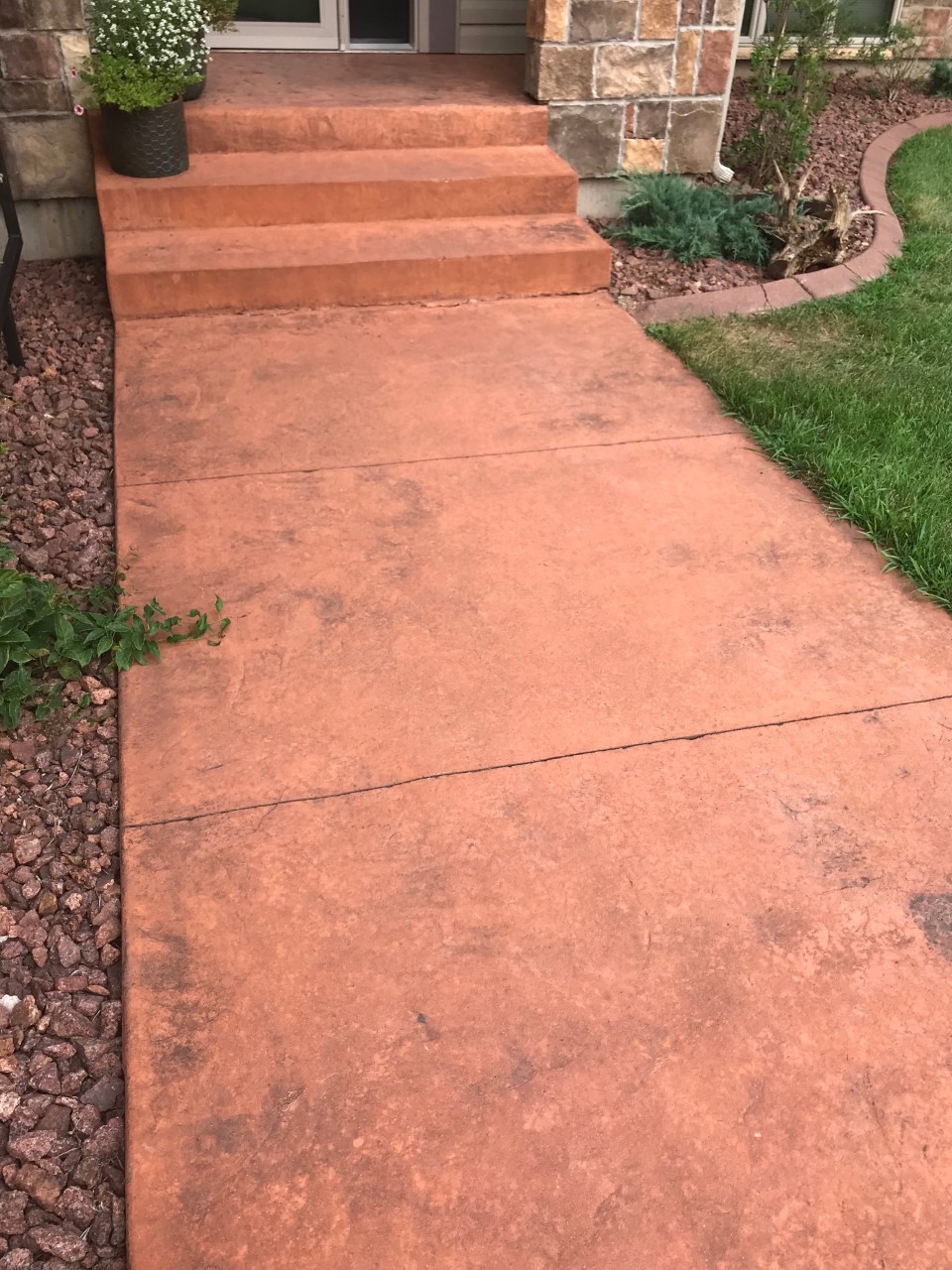 Pinkish orange stamped concrete walkway