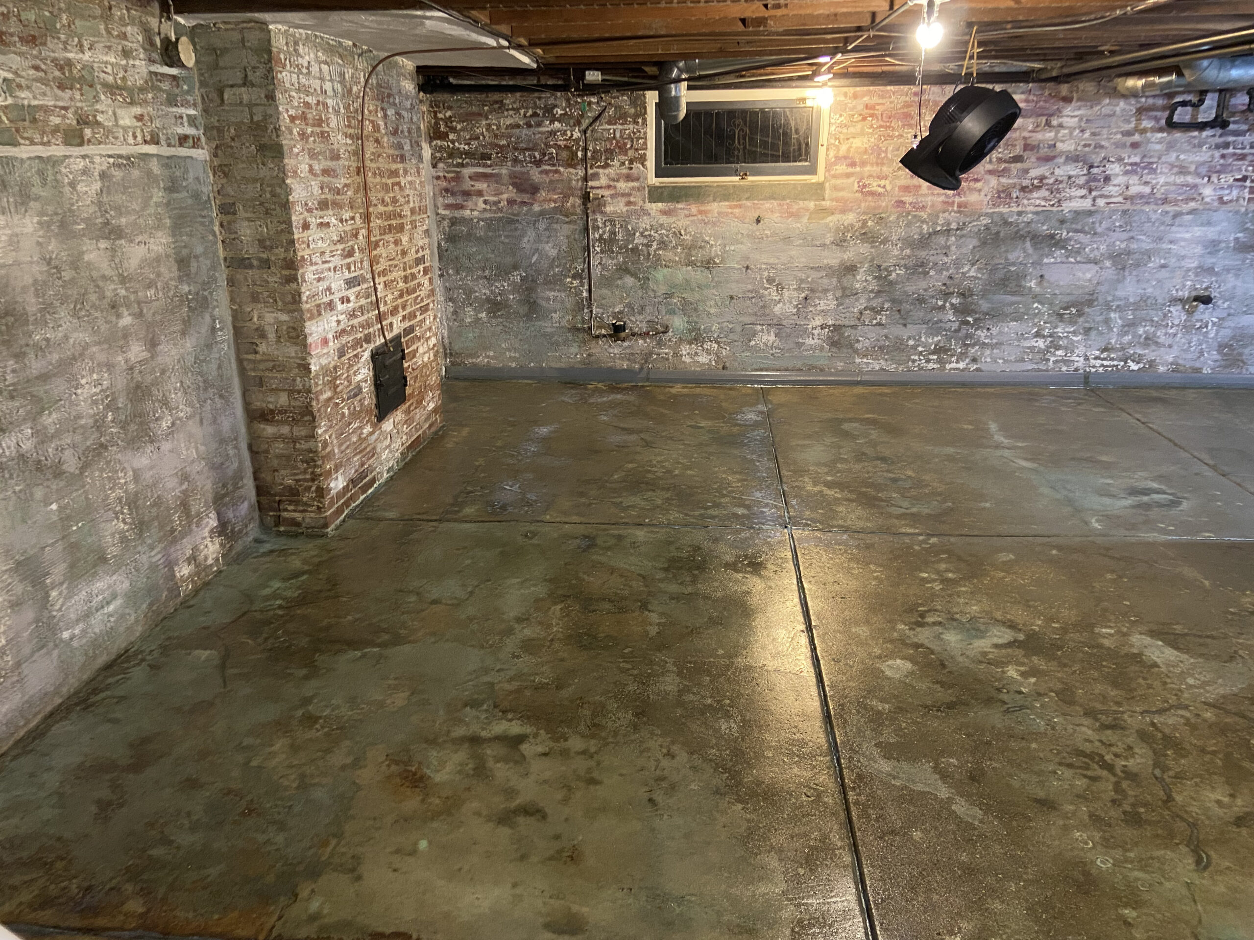 Stained concrete basement floor with Azure Blue and Seagrass acid stains