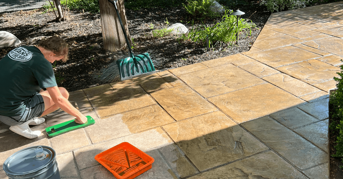 DIYer applying Tweed EasyTint™ to a dull stamped concrete patio.