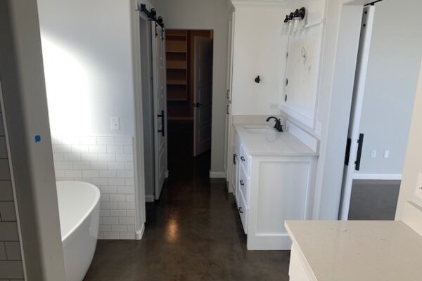 Concrete bathroom floor dyed with a blend of Stormy Gray, Driftwood, and Charcoal Vibrance Dye