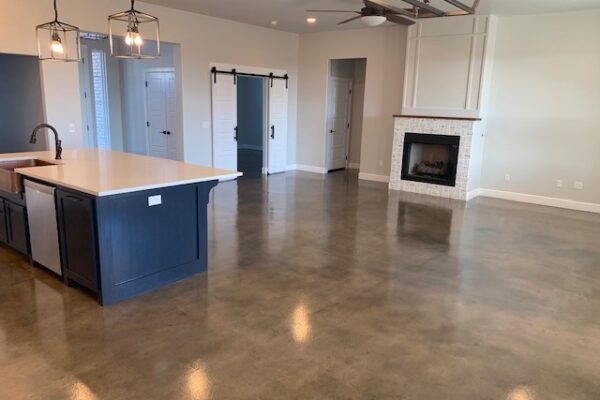 Living room concrete floor beautifully stained with Stormy Gray, Driftwood, and Charcoal Vibrance Dye