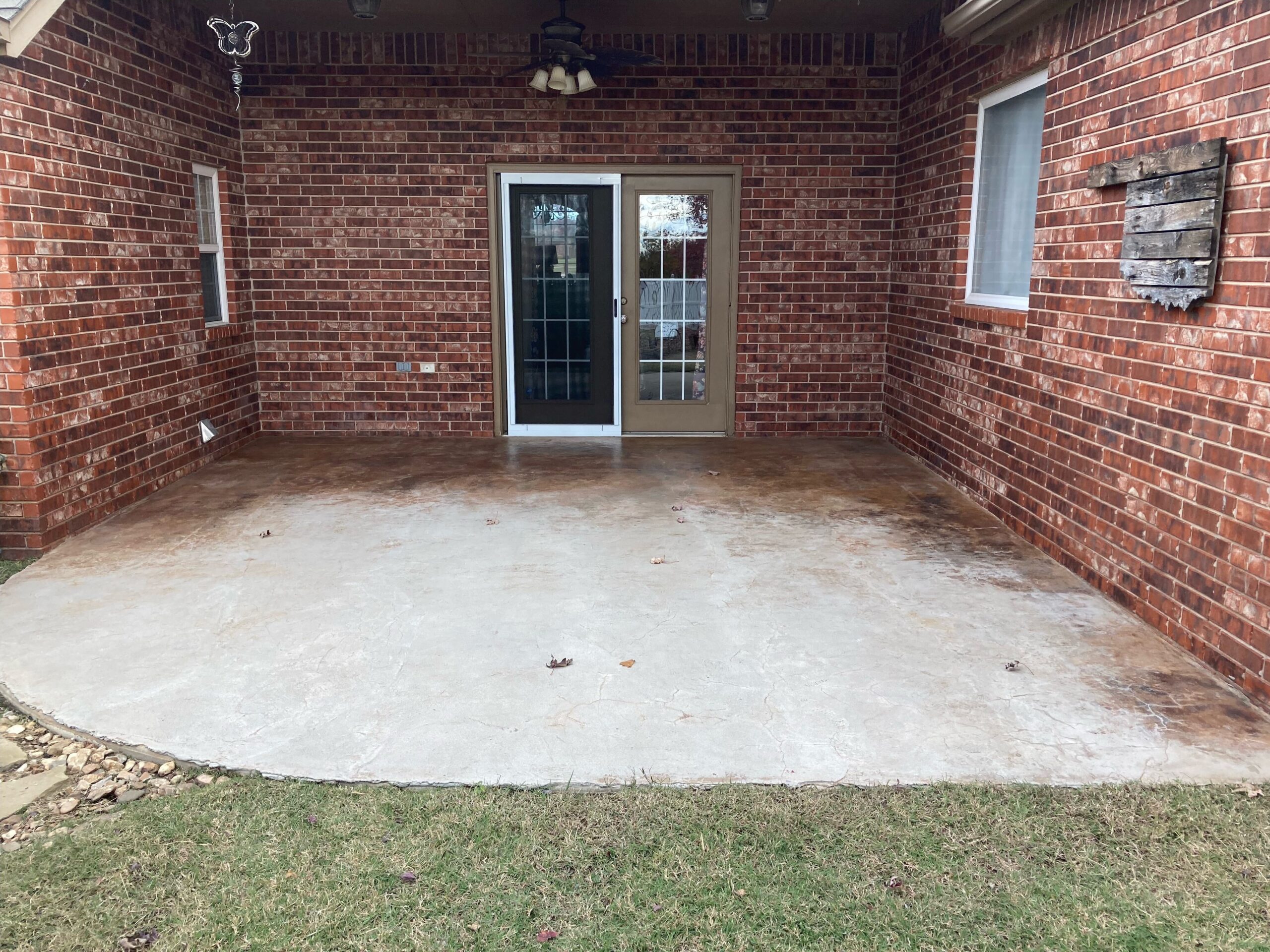 A before photo of a plain covered concrete patio