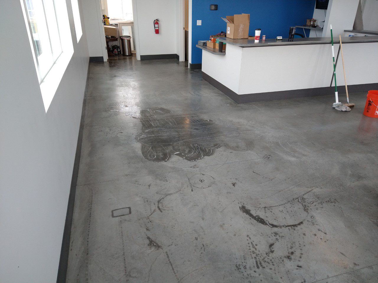 Commercial concrete floor in its original, faded gray state