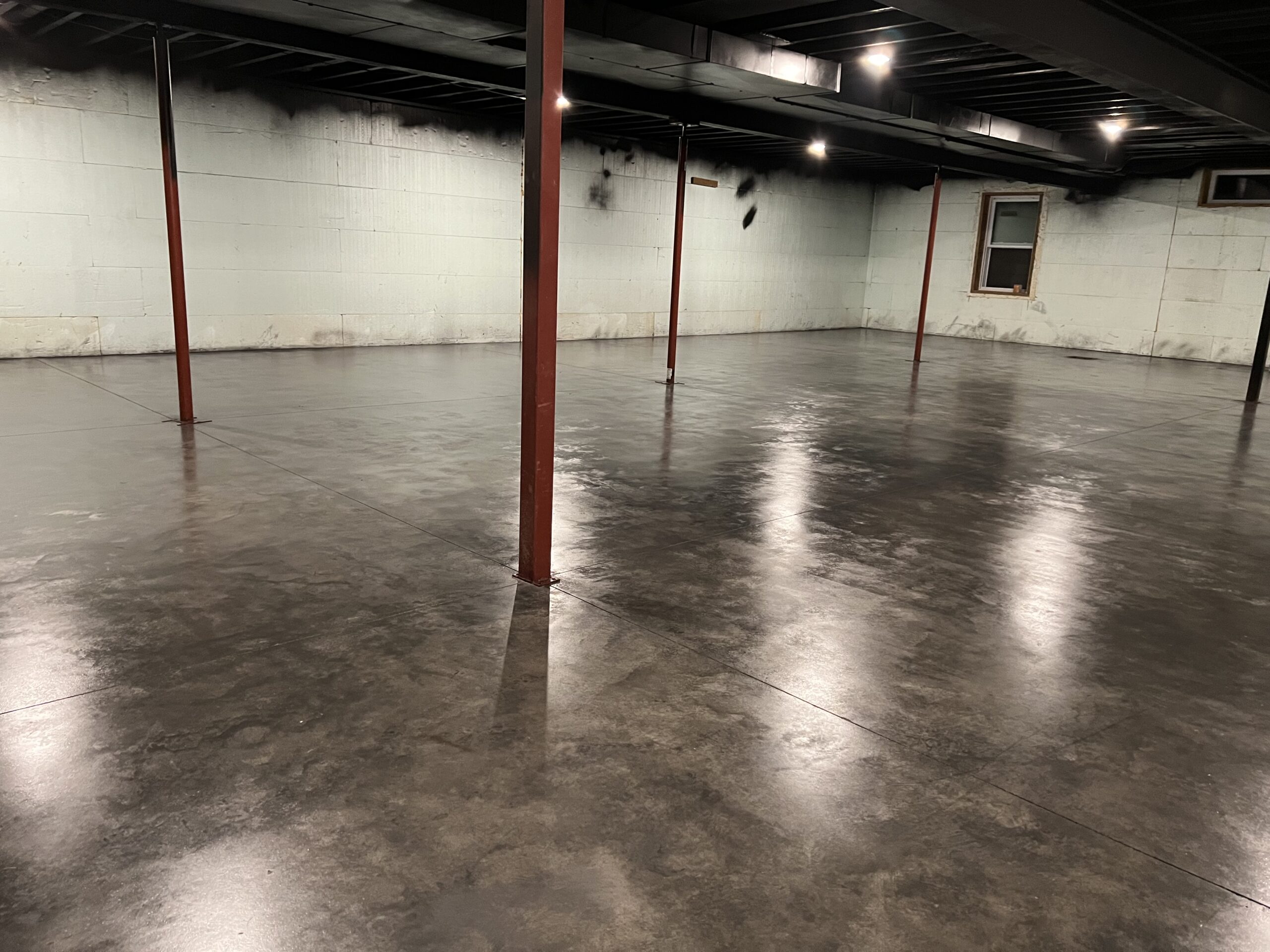 Image of the basement floor after the second coat of AquaTint.