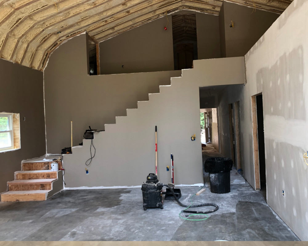 using a shop vac to clean the concrete floors before staining