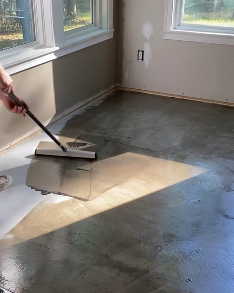 Homeowner applying Charcoal AcquaTint™ using an 18" squeegee for a swirl finish