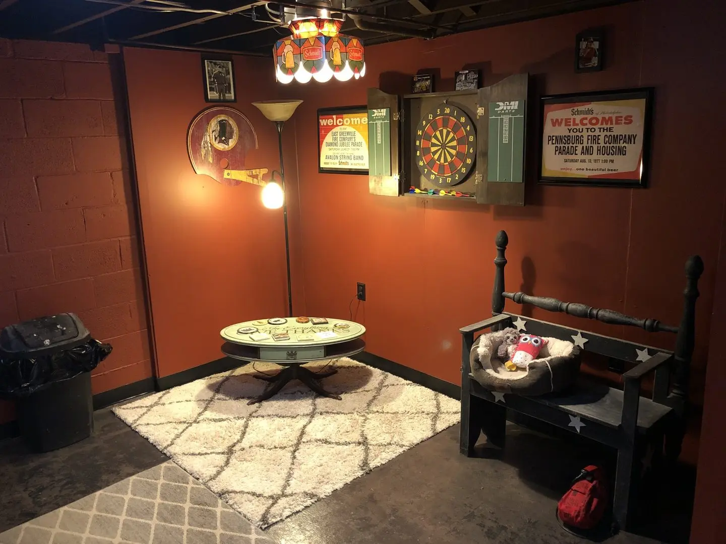 Newly revamped basement featuring a dart board and various fun posters on the walls