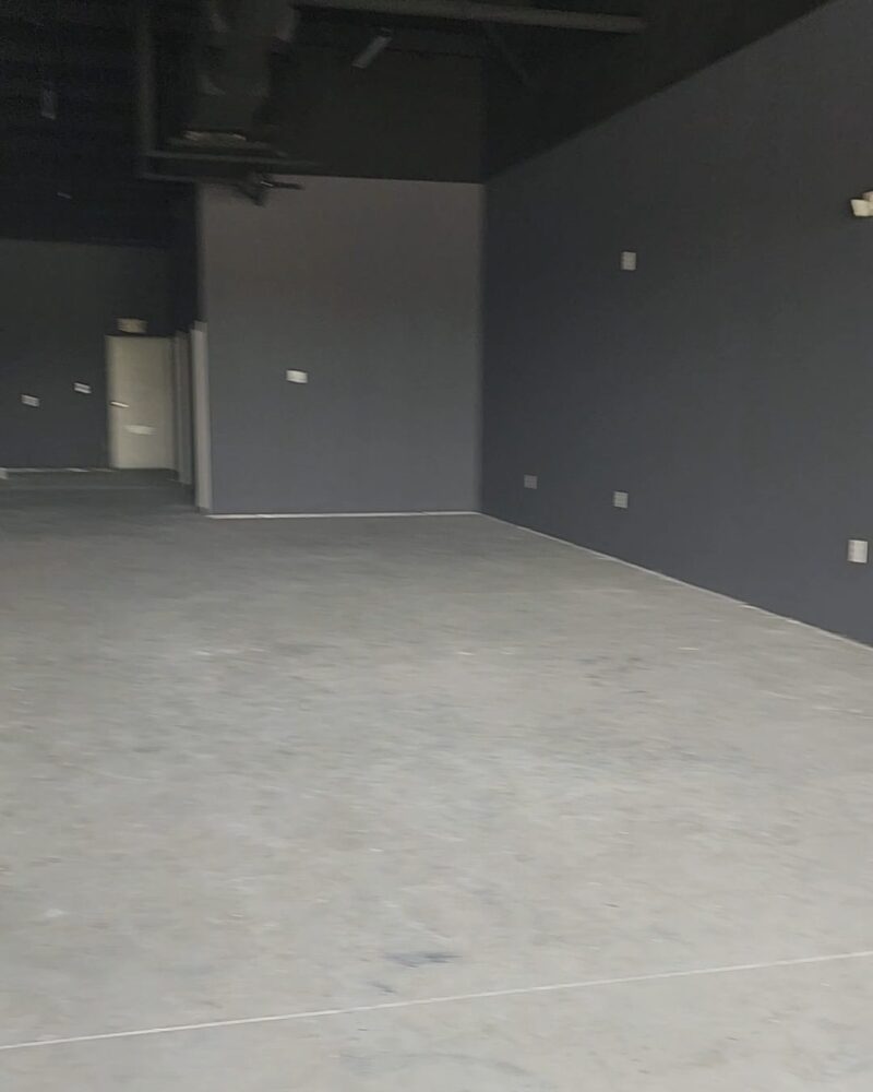 Unfinished concrete floor in a salon waiting for transformation.