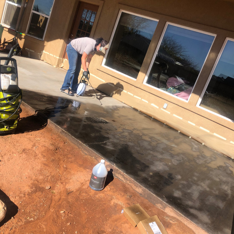 Black outdoor concrete stain application with pump up sprayer