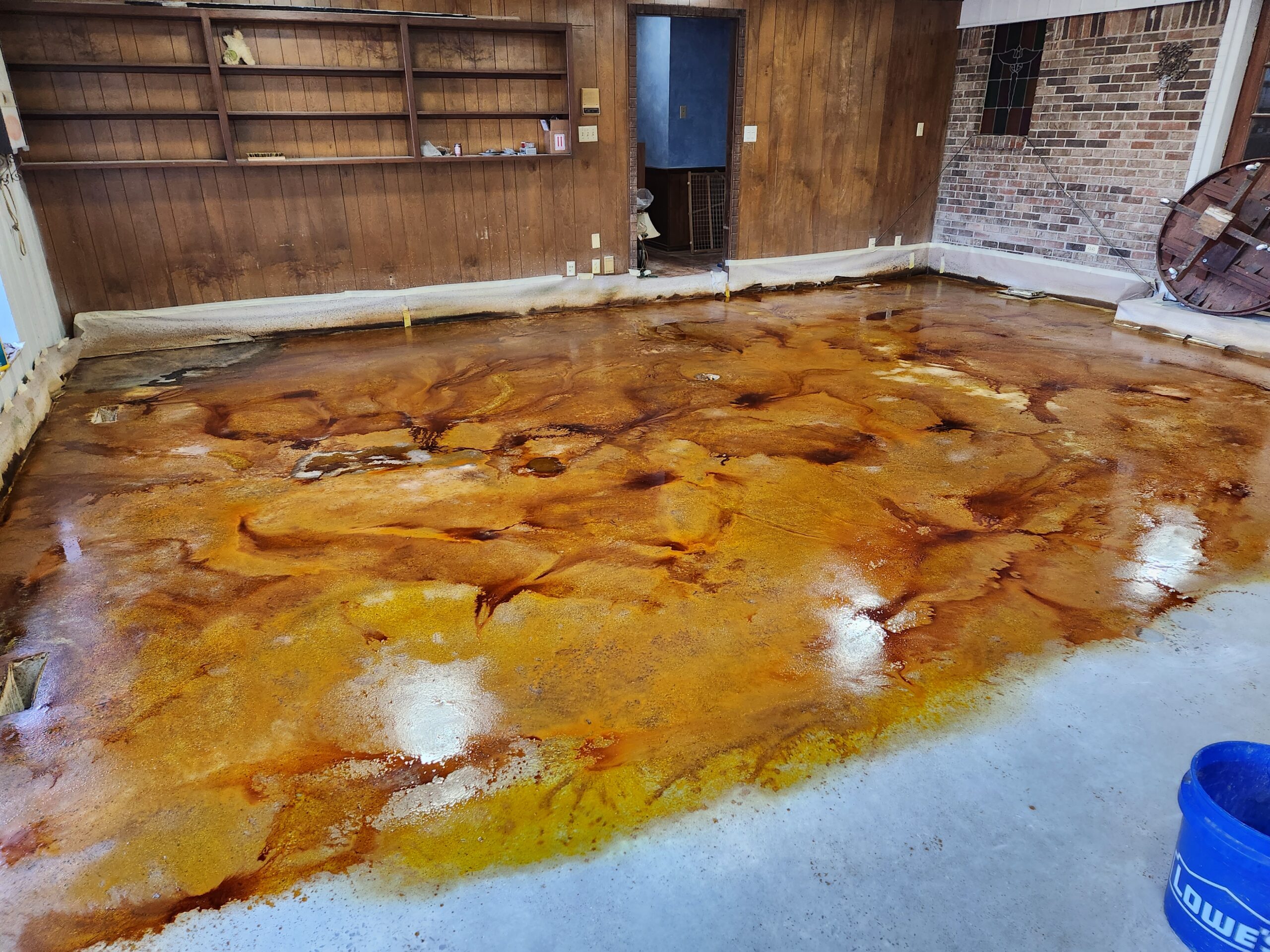 Concrete floor of the game room post application of Cola, Coffee Brown, and Desert Amber EverStain™ acid stains