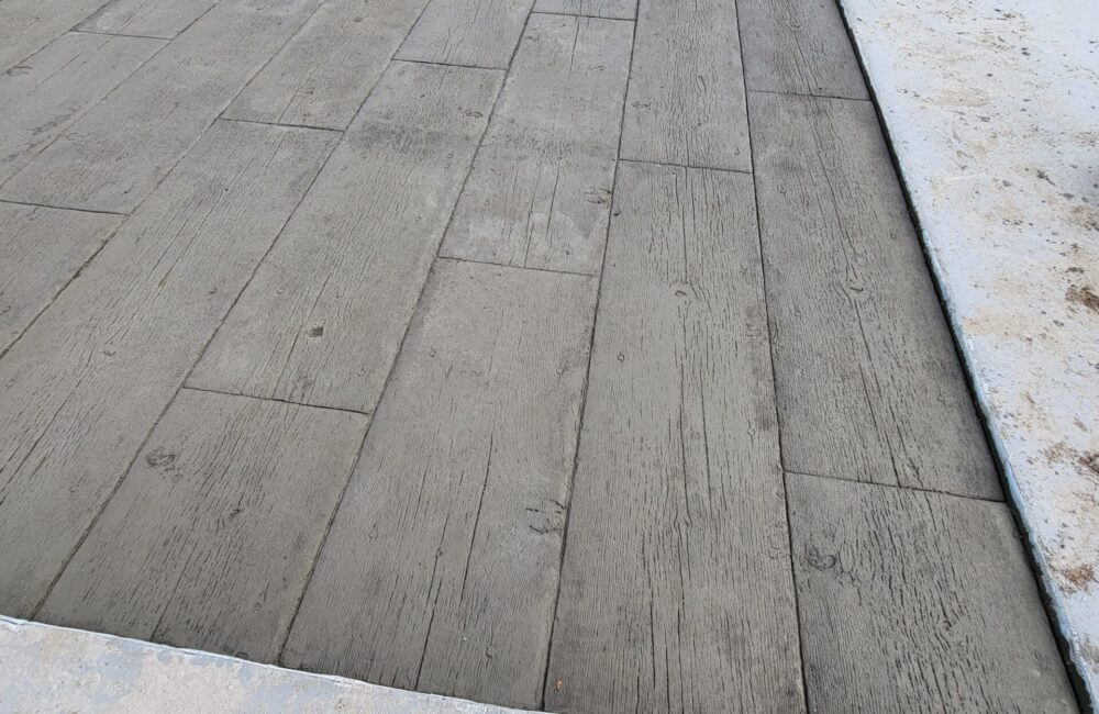 "Freshly stamped concrete slab, designed to mimic the pattern of wood planks