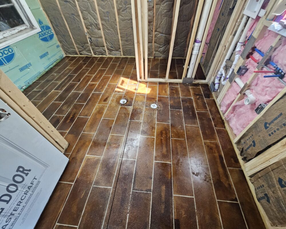 Final look of the faux-tile floor after applying two layers of sealer, showcasing its glossy finish