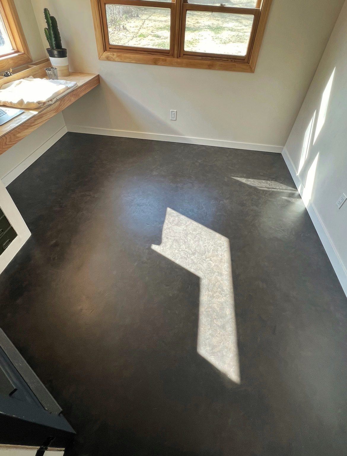 Concrete floor showcasing a sophisticated blend of Stormy Gray and Charcoal Vibrance Dye after the final coat.