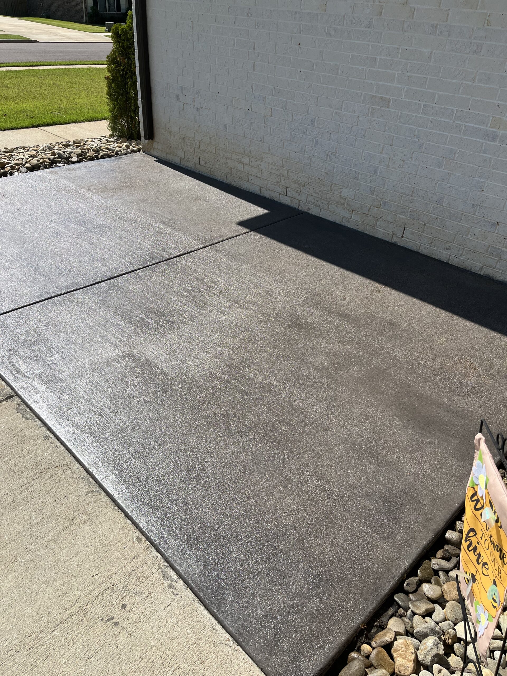 Antiquing Charcoal stained broom finish concrete patio