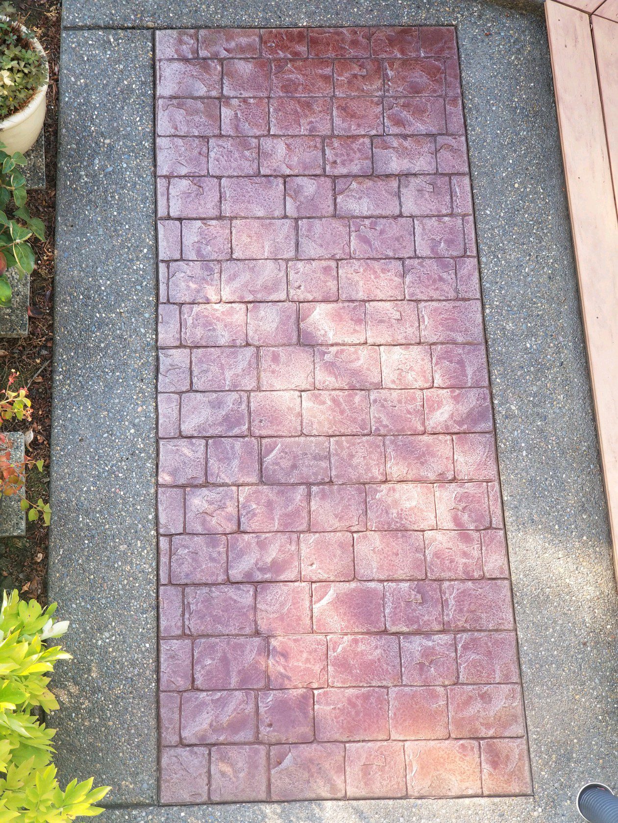 Patio floor with rich Cinnabar staining, sealed to perfection, showcasing enhanced color vibrancy.