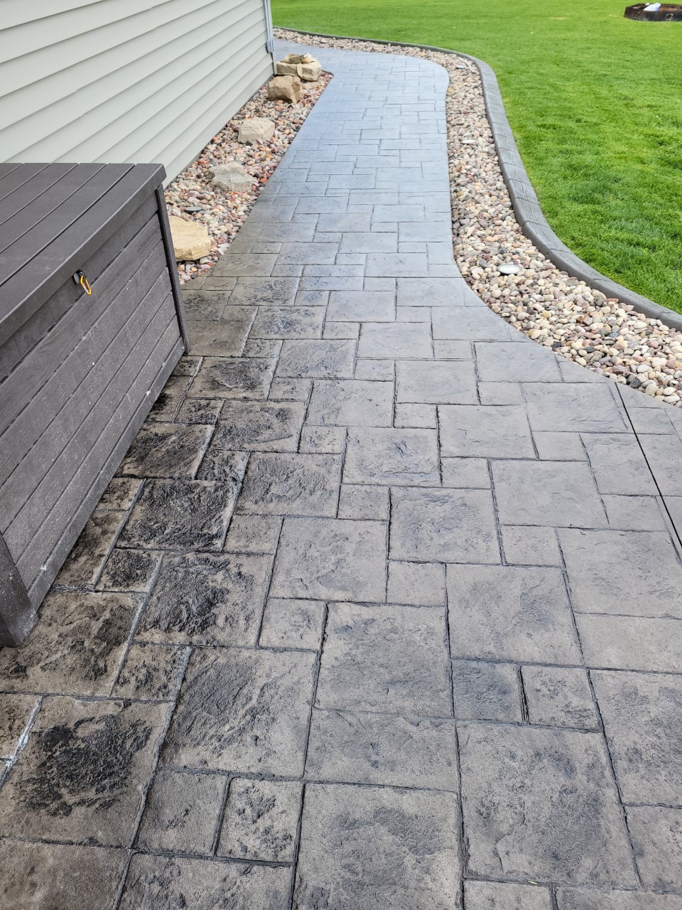 Antiquing Charcoal stained stamped concrete walkway