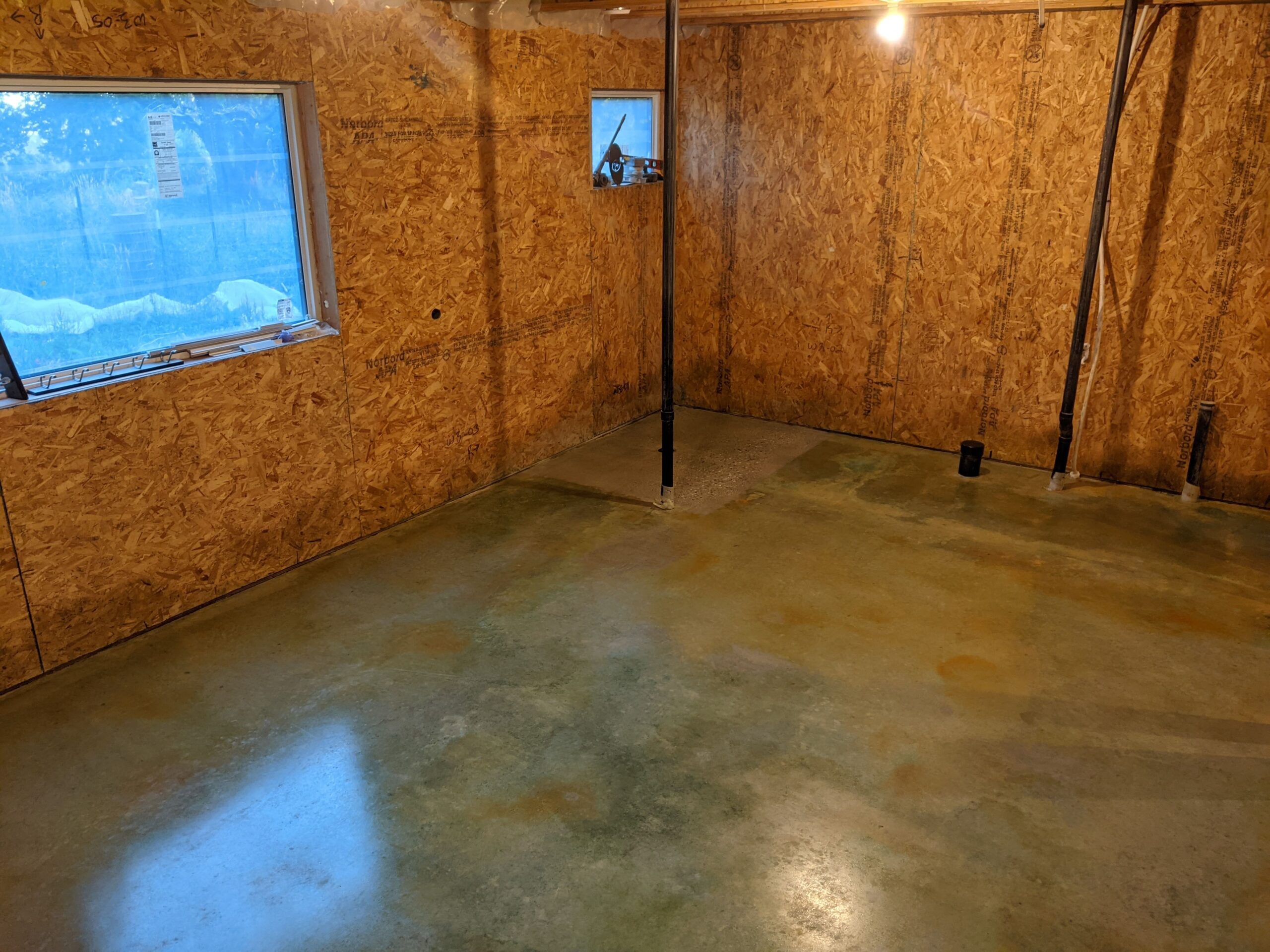 Stained concrete basement floor with Avocado acid stain