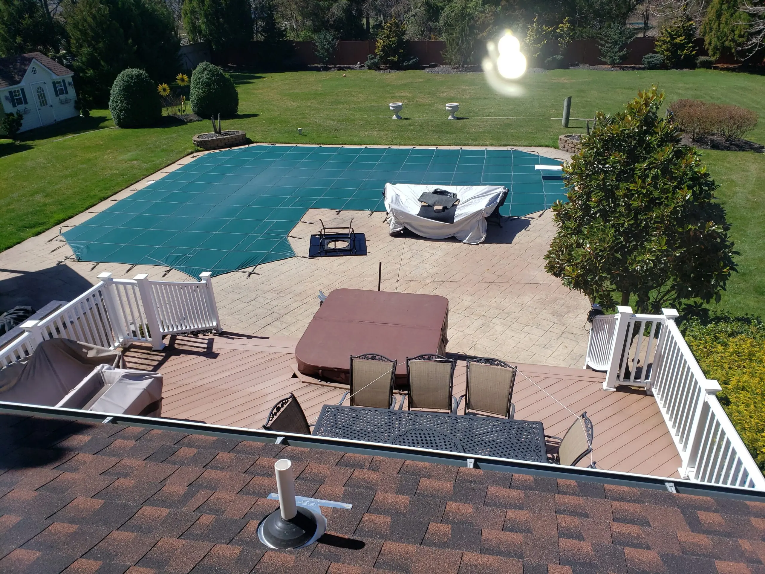 Pre-stain photo of the stamped concrete pool deck, last stained a decade ago and showing visible wear and cracks