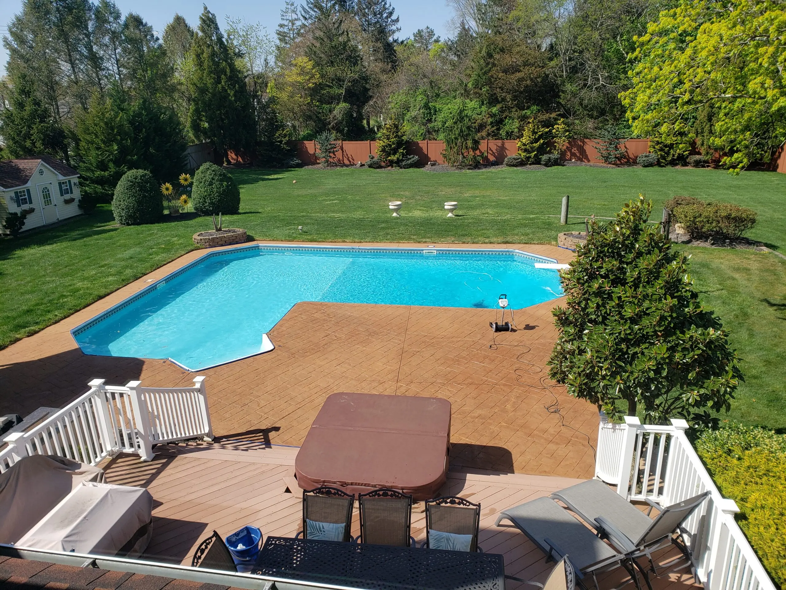 Post-stain photo of the stamped concrete pool deck, now revitalized with Cumin Antiquing Stain and Satin EasySeal
