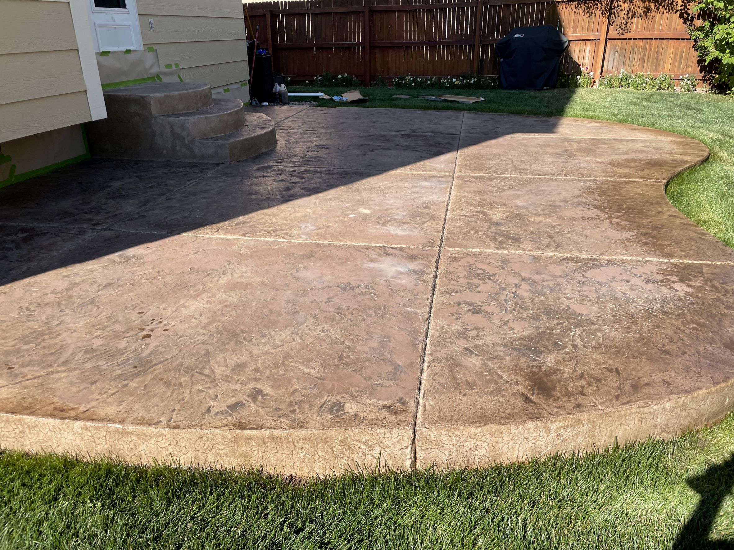 Faded integrally colored stamped concrete patio before the application of Antiquing™ Stain