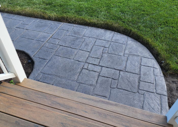 Close-up view of the revitalized sidewalk with charcoal antiquing stain and satin sealer