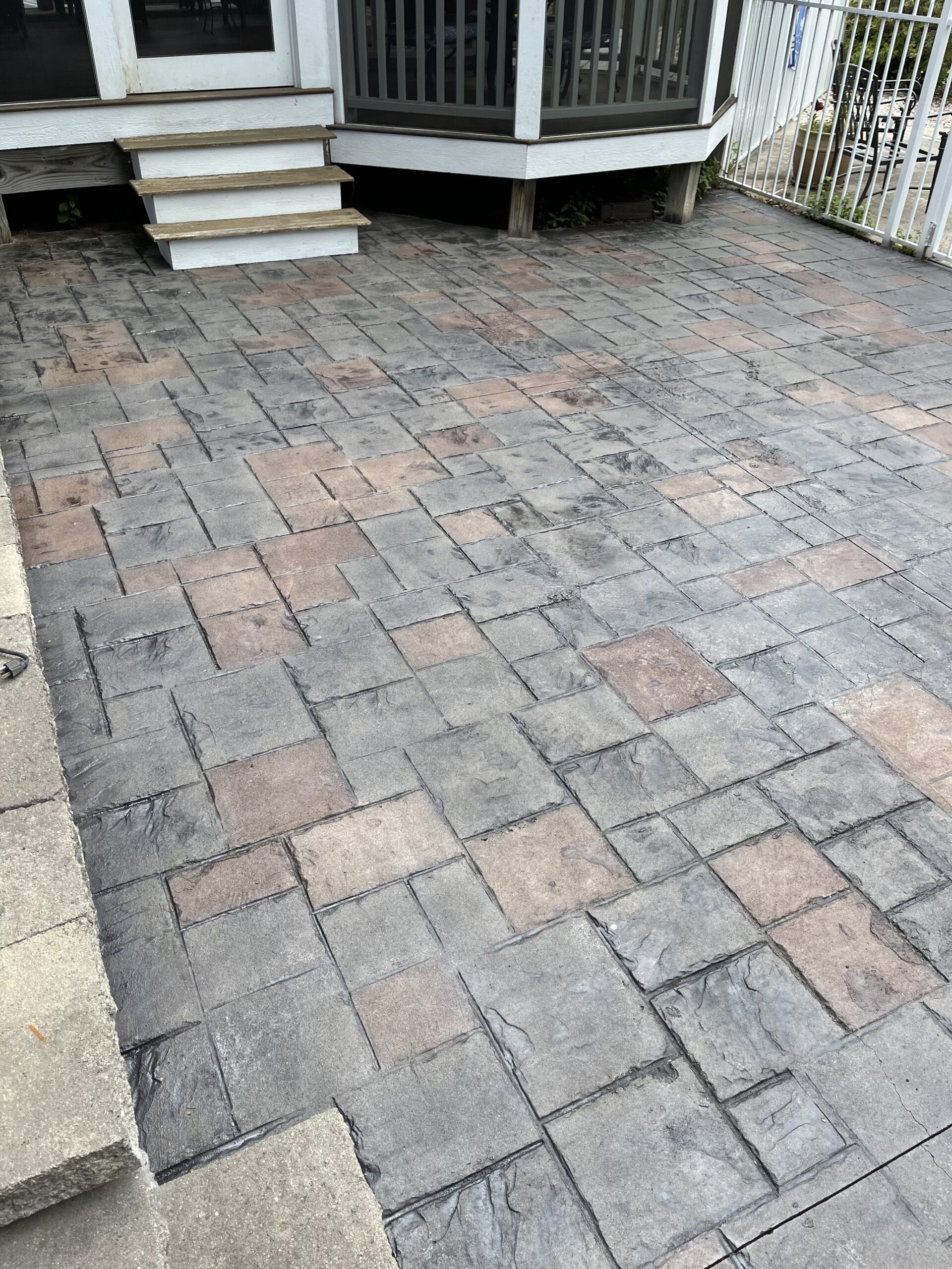 Backyard patio revitalized with light charcoal and auburn antiquing stain