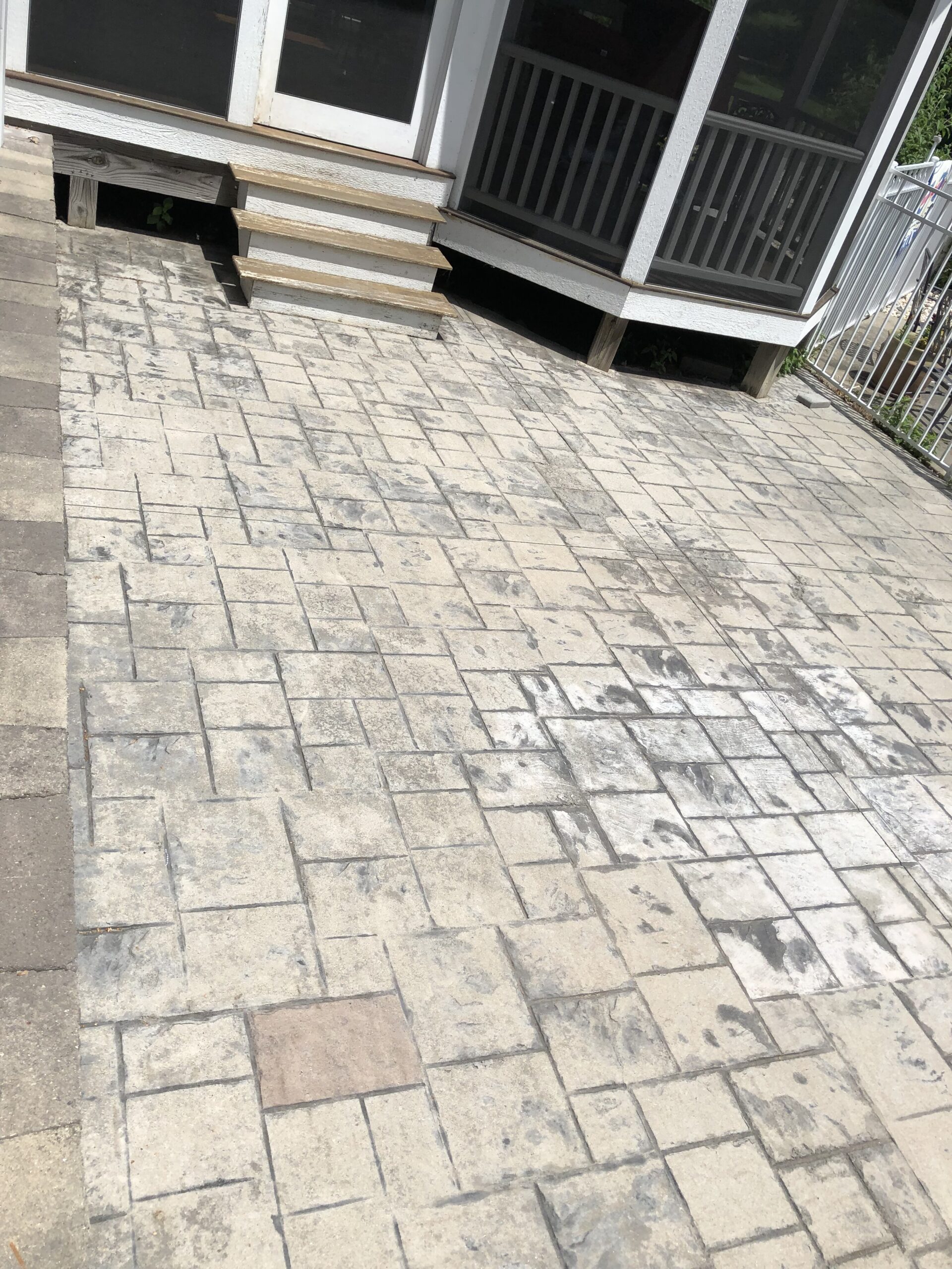 Faded and discolored stamped concrete patio