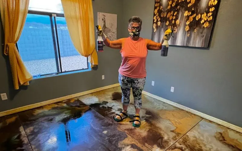 Safety first: A woman wearing protective gear for applying acid stain to the concrete surface