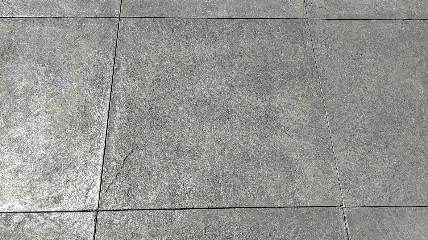 Close-up of 36-inch hand-poured, slate-stamped squares using a Silver Gray Antiquing stain and satin EasySeal