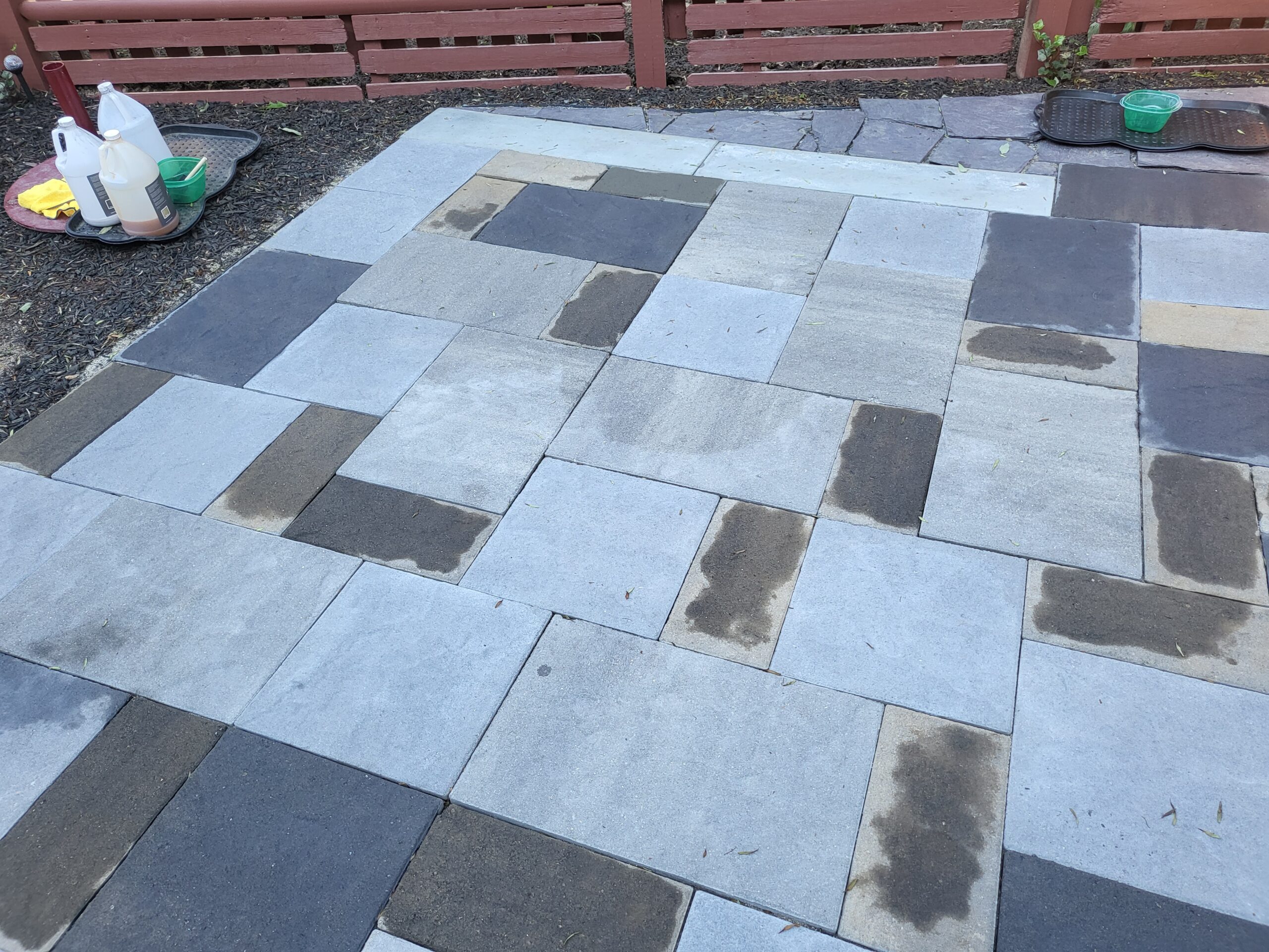 Image showing a slate-stamped concrete patio, freshly stained with three different Antiquing stain colors, currently drying and awaiting the sealing process to lock in the vibrant hues