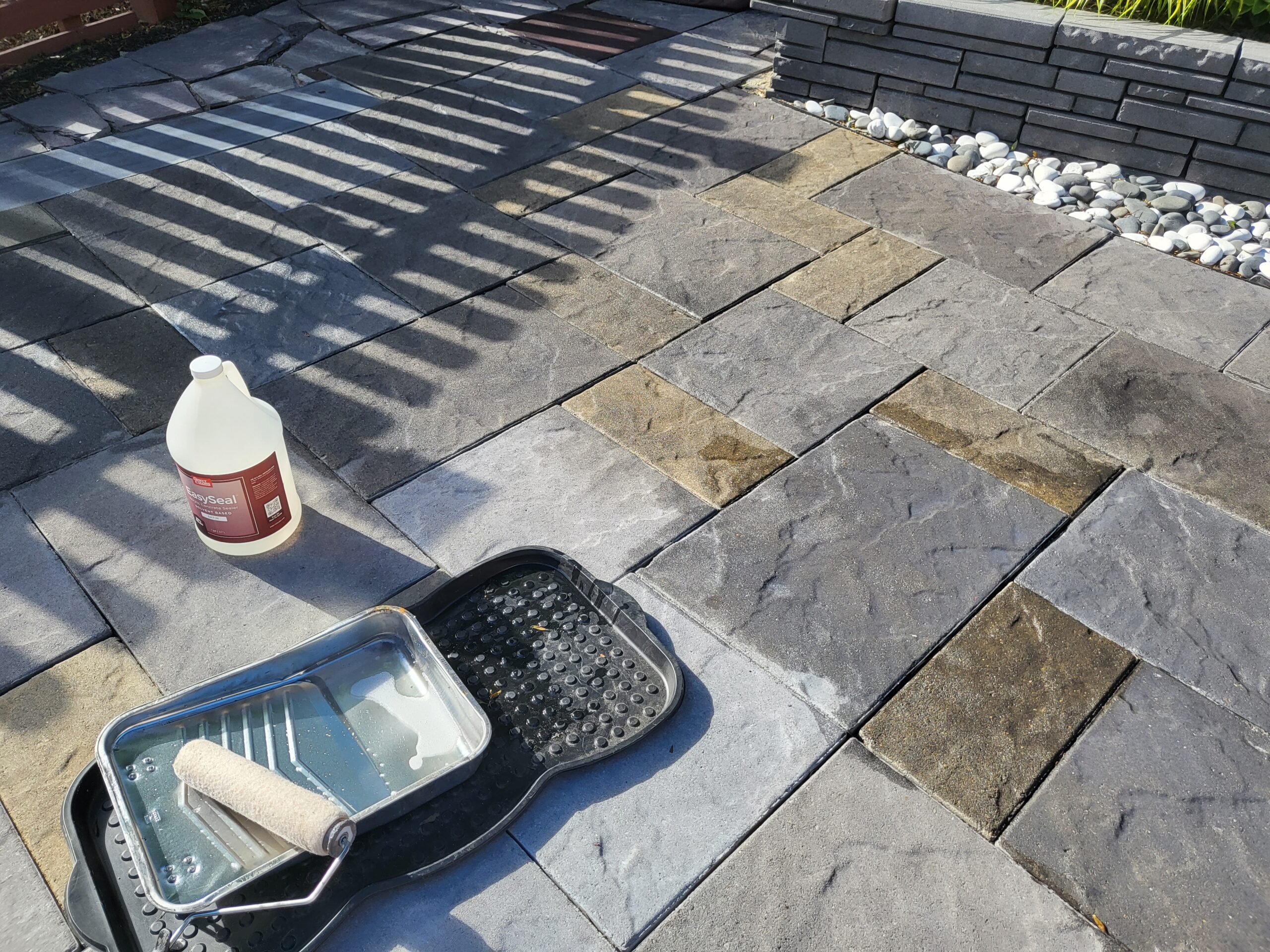 Image illustrating the application of EasySeal with a foam roller over the Antiquing stain on a concrete surface, a process that enhances and seals in the vibrant stain colors for a more striking appearance