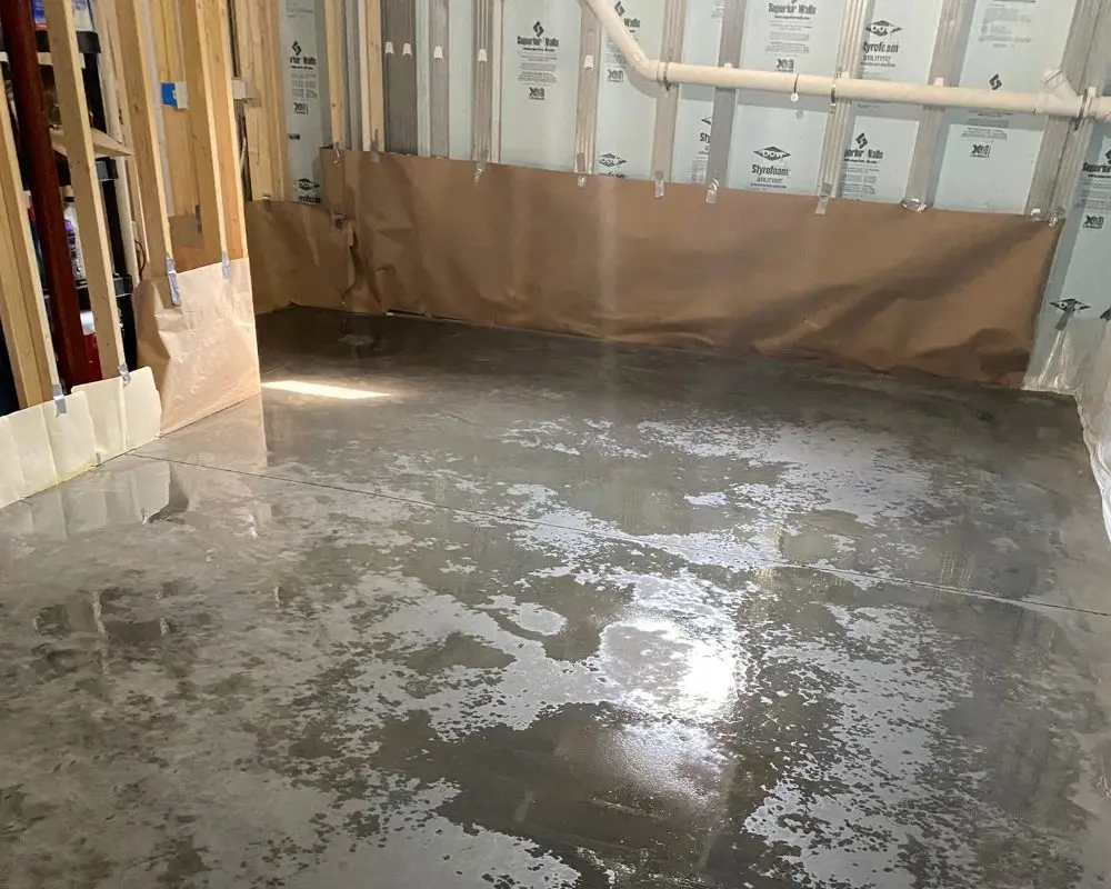 Applying CitrusEtch solution to a concrete floor to prep for acid stain