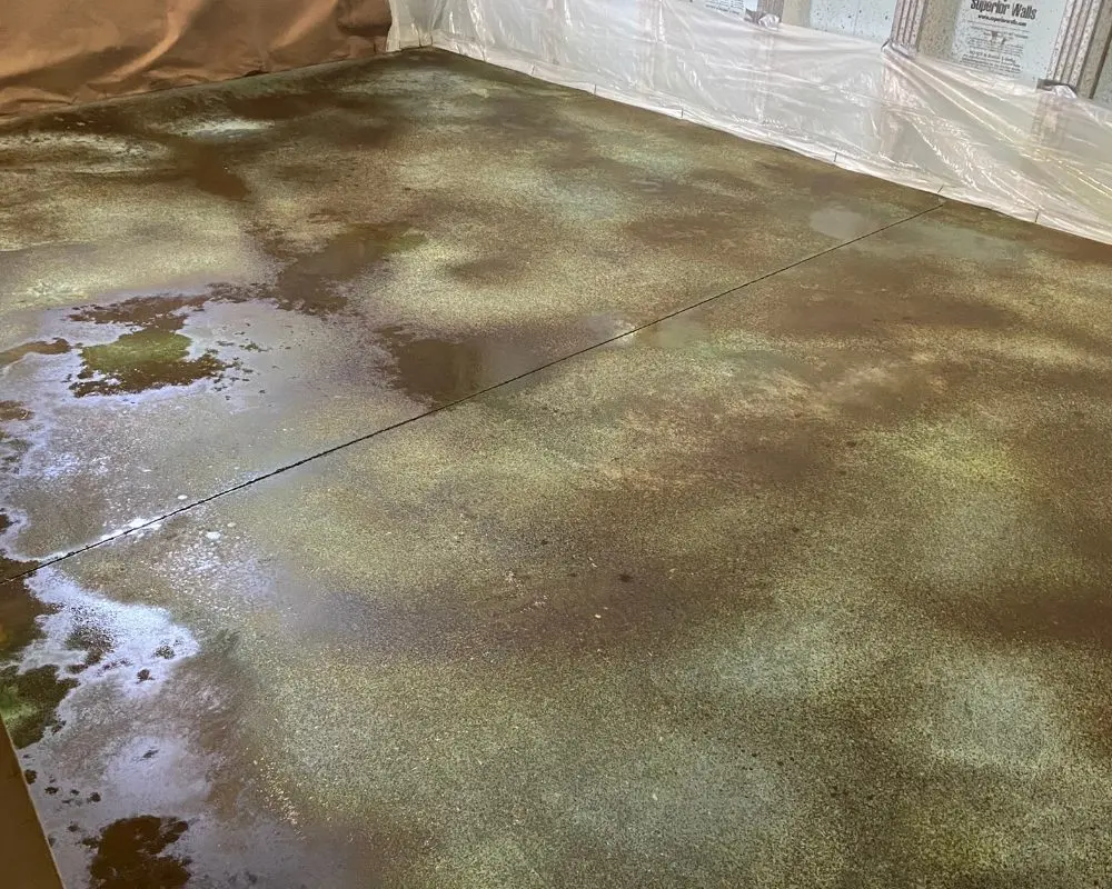 Concrete floor with drying Coffee Brown spots, highlighting the color variances