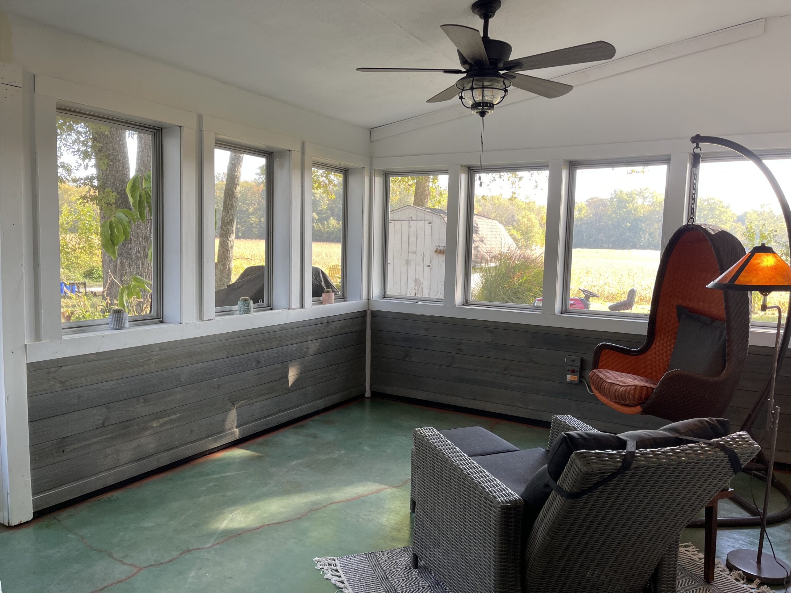 Another angle of the finished sunroom floor showcasing the intricacy of the acrylic paint veining accents against the azure blue stain