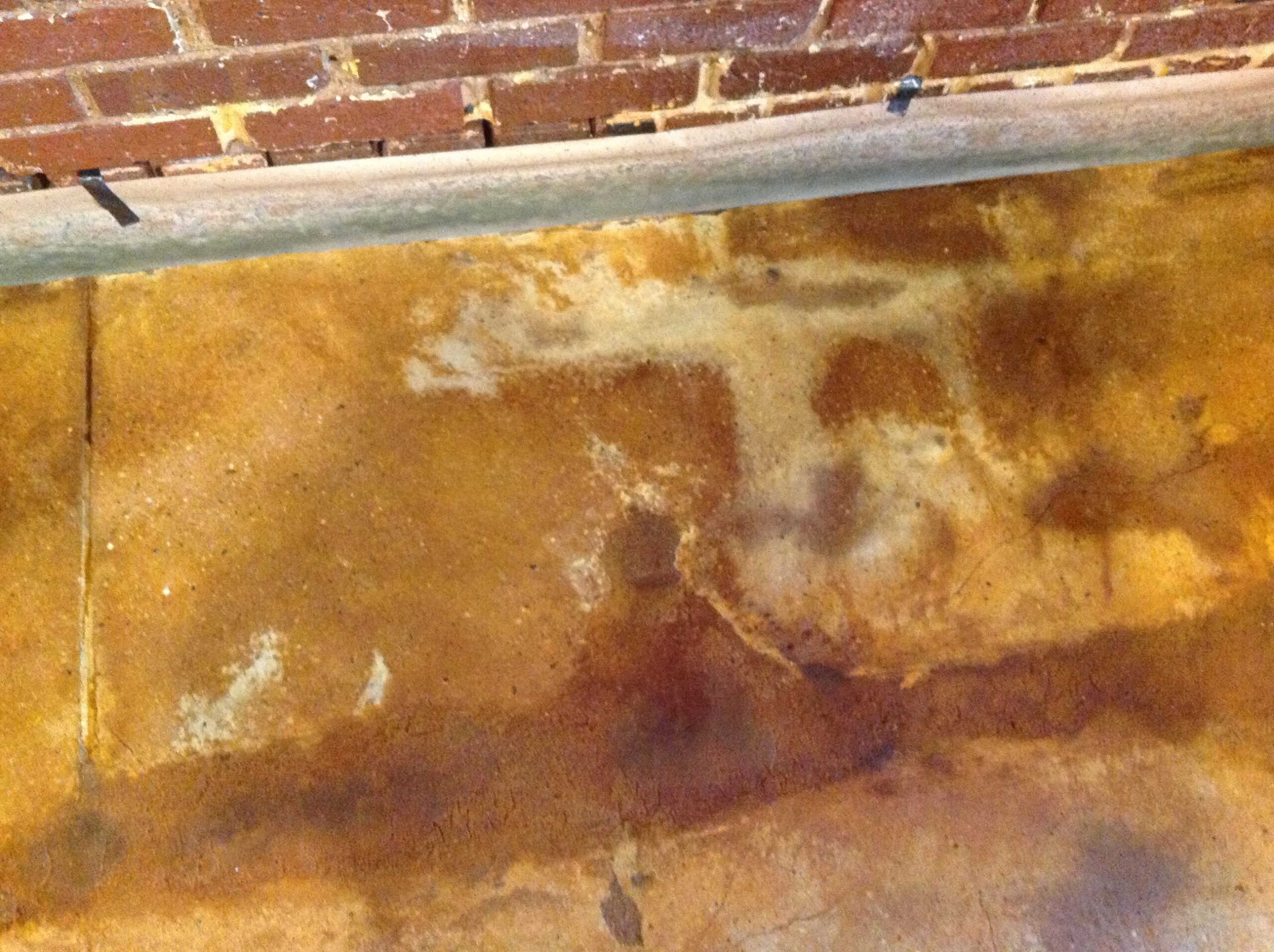Close-up image of a portion of the floor after acid stain application, showcasing areas that did not accept the stain