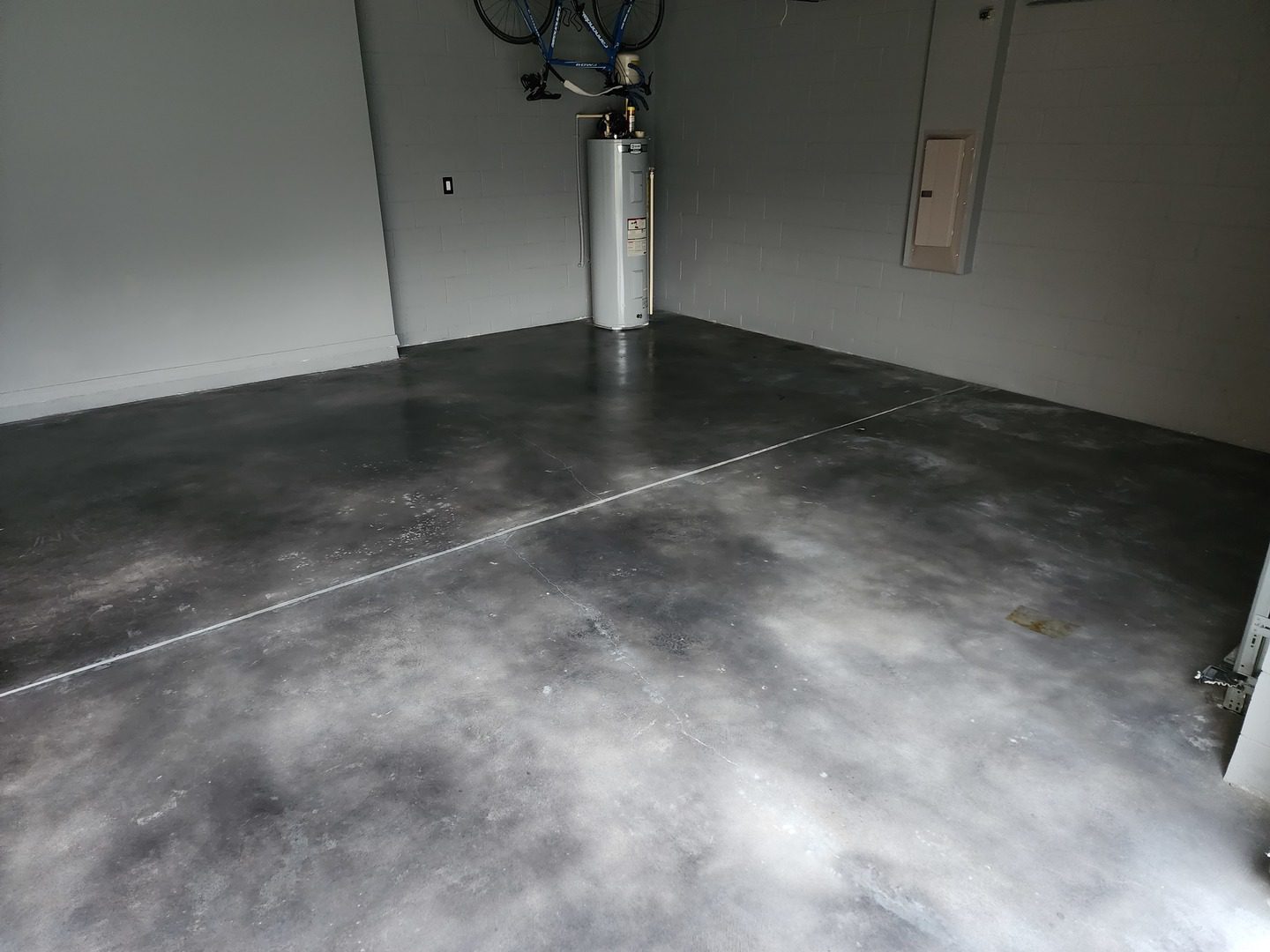 Garage space with a faux polished concrete floor using Black, Stormy Gray, and White Vibrance Dye