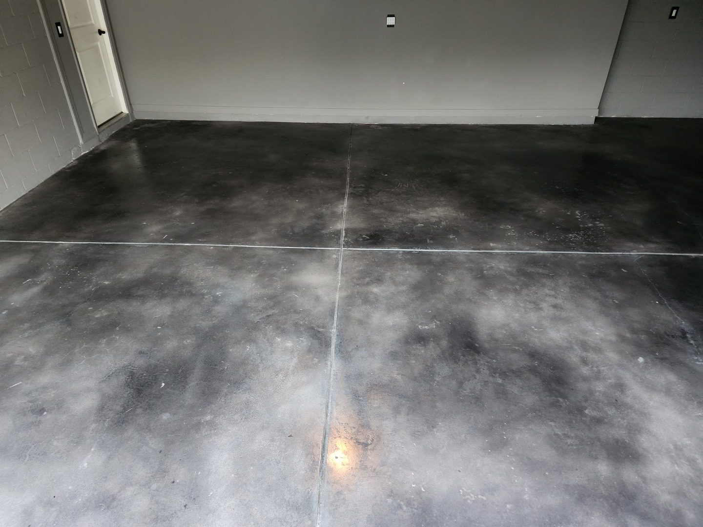 Garage space with a faux polished concrete floor using Black, Stormy Gray, and White Vibrance Dye