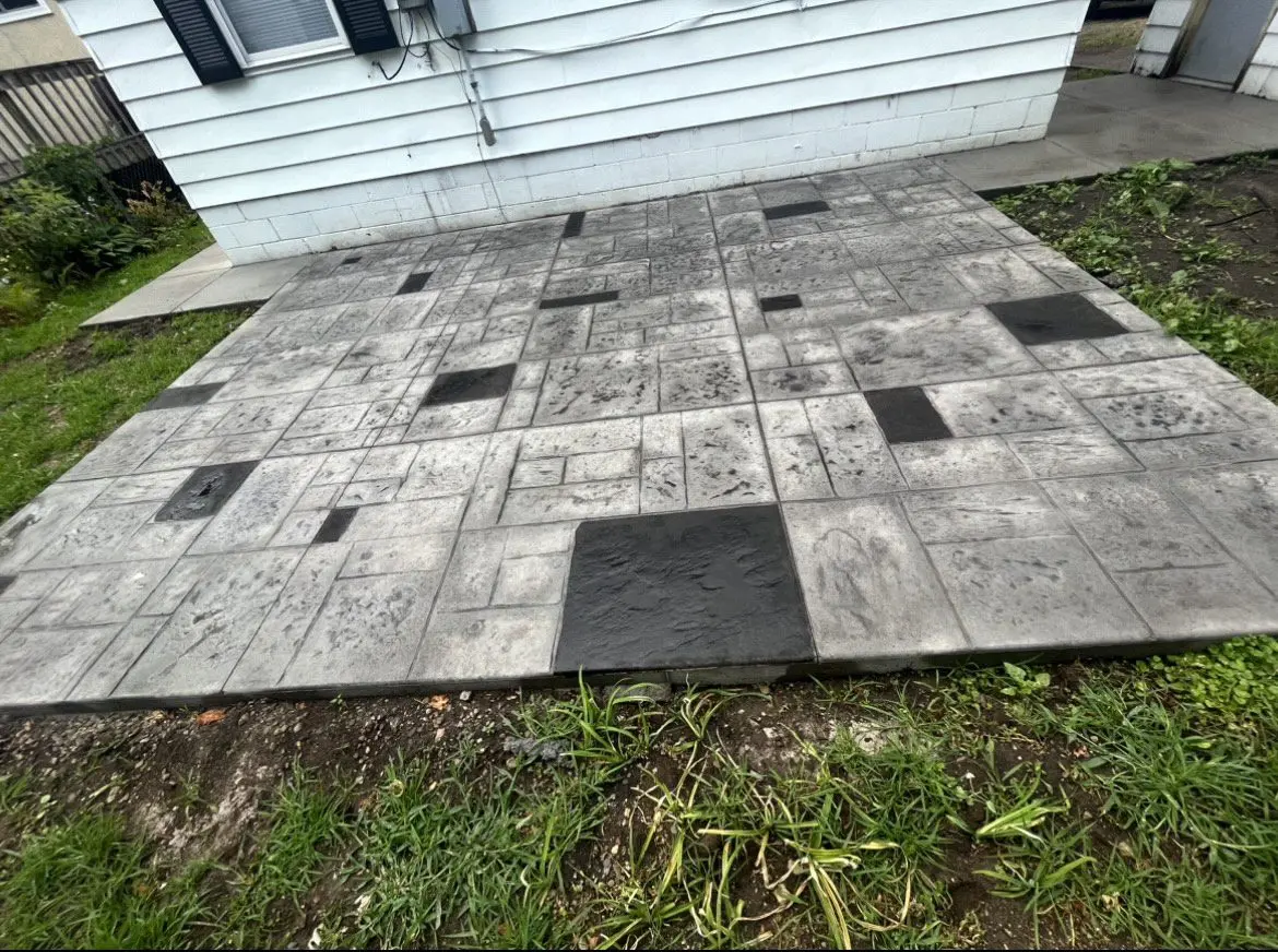 Stamped concrete patio with distinct tiles accentuated by the added Black EverStain Acid Stain