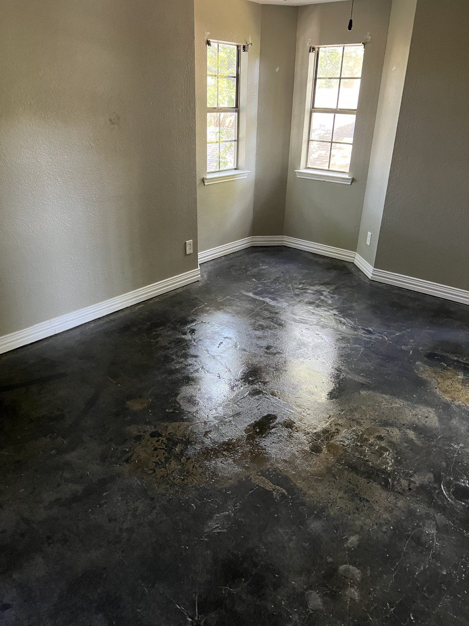 Alternate angle of the striking black stained concrete floor featuring a harmonious blend of black, stone gray, and iron gray ColorWave water-based concrete stains.