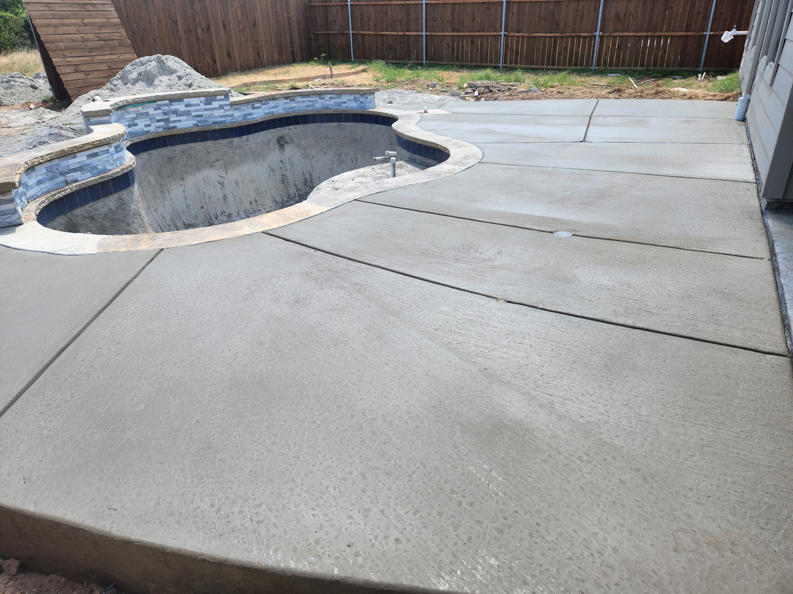 Newly poured broomed finish concrete pool deck